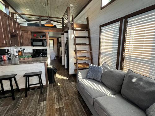 a living room with a couch and a kitchen at CreekFire RV Resort in Savannah