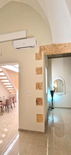 a room with a hallway with a table and a mirror at Xenia Boutique Apartment in Trepuzzi