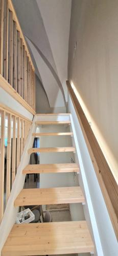 a staircase with wooden risers in a house at Xenia Boutique Apartment in Trepuzzi
