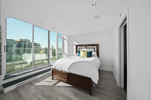 a bedroom with a bed and a large window at Skyline Hideaway in Vancouver