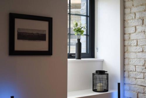 a room with a window with a vase on a shelf at Prison Conversion Flat with Parking in Portsmouth