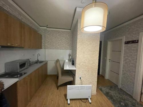 a kitchen with a sink and a table in a room at Mujen Lux Kopaonik - Superior Apartman in Kopaonik