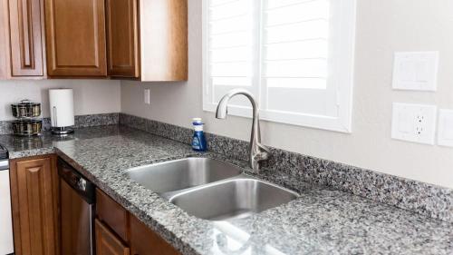 a kitchen counter with a sink and a window at Updated Condo in A Old Town Scottsdale Location in Scottsdale