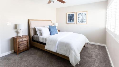 a white bedroom with a bed and a night stand at Updated Condo in A Old Town Scottsdale Location in Scottsdale
