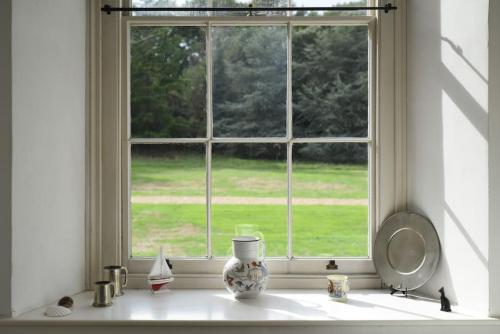 a window with a vase on a counter in a kitchen at Naval Officers Quarters Flat in Gosport