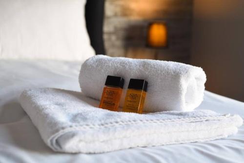 two bottles of moisturizers sitting on a towel on a bed at Amazing view High end beachfront 3BR 5beds 7 guest in South Hayling