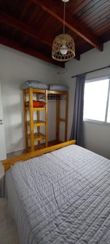 a bedroom with a large bed and a window at El Bagual de Monte XL in San Miguel del Monte