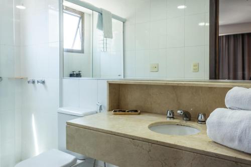 a bathroom with a sink and a shower and a toilet at Xtay Privillege Botafogo in Rio de Janeiro