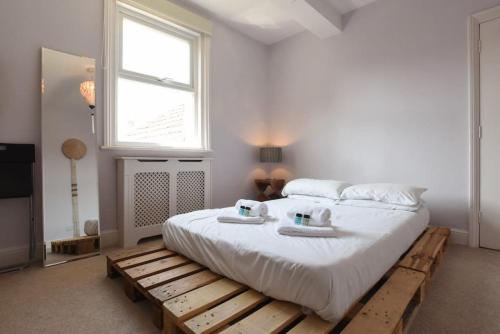 a bedroom with a bed on a wooden pallet at 2bed flat central Southsea 5 mins to beach in Portsmouth