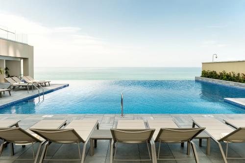 una piscina infinita con mesa y sillas en un edificio en Hyatt Regency Cartagena, en Cartagena de Indias