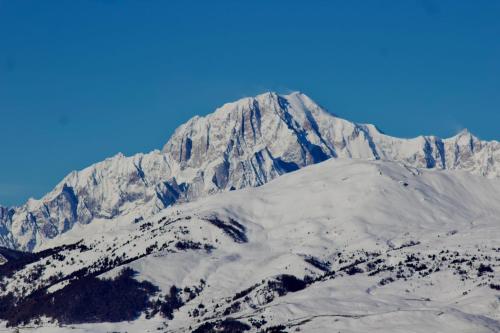 a mountain covered in snow with a blue sky at Ca' De Sass in Pila