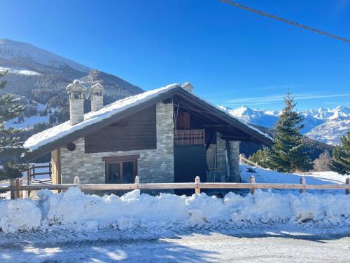 a log cabin in the mountains with snow around it at Ca' De Sass in Pila