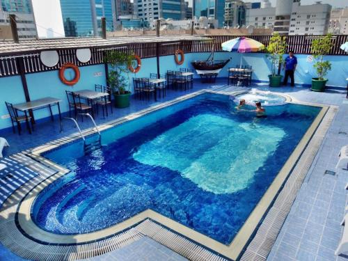 a swimming pool on top of a building at Knight Armour Hotel in Dubai