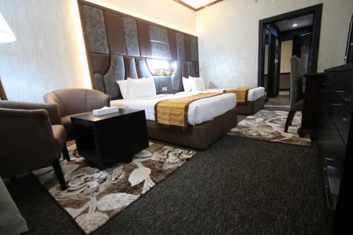 a hotel room with a bed and a couch at Knight Armour Hotel in Dubai