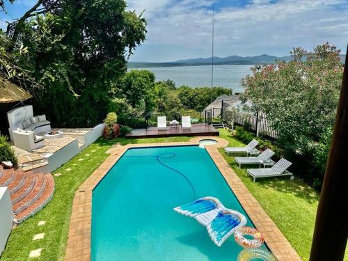a swimming pool in the backyard of a house at ScenicViews@103 in Hartbeespoort