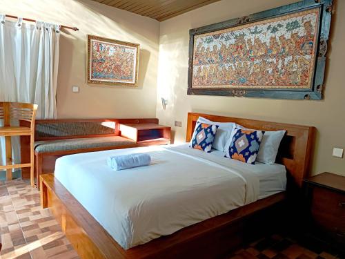 a bedroom with a large bed and a couch at S Bali Villa in Nusa Dua