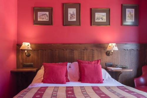 a red bedroom with a bed with pink walls at Hotel Aran La Abuela in Vielha