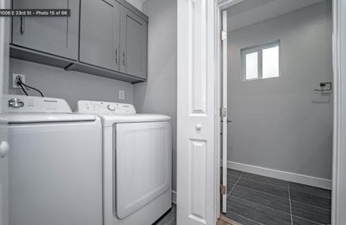 a white laundry room with a washer and dryer at Green HomeStay address changed in Los Angeles