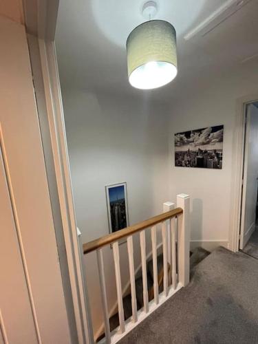 a room with a staircase with a light and a stair case at Tootle Drive in Longridge