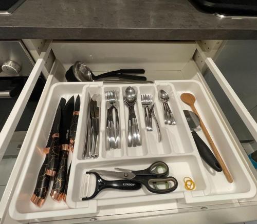 a white tray with utensils in a drawer at Apisha Appartement in Kirchheim unter Teck