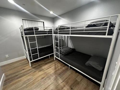 a room with three bunk beds in a room at Green HomeStay address changed in Los Angeles
