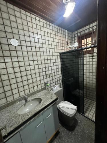 a bathroom with a sink and a toilet at Suítes no São Francisco - Casa de Hospedagem Ferreira in São Luís