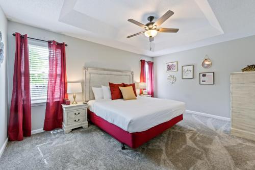 a bedroom with a bed and a ceiling fan at Fully Fenced & Stylish 3BR Near LakePoint Sports in Cartersville