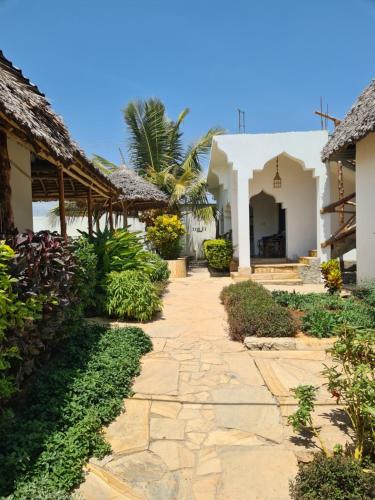 a walkway in front of a house at Blue Moon Villa in Pwani Mchangani Mdogo