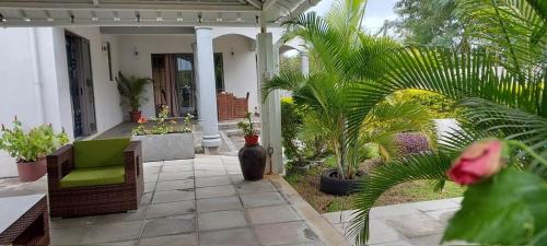 a porch with a green chair and some plants at Serenity Villa in Balaclava