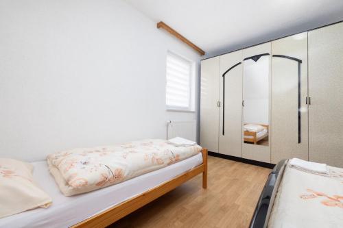 a bedroom with a bed and a closet at Apartman BARIŠIĆ 2 in Kupres