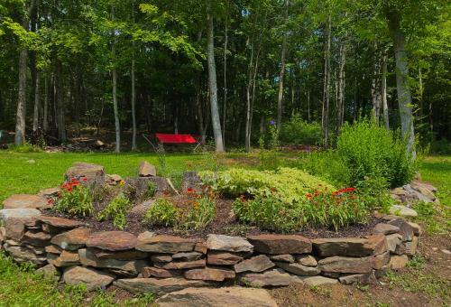 a rock garden with flowers in a yard at Bucksport Inn in Bucksport