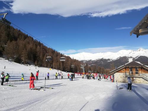 a group of people skiing on a ski slope at La Casa Shabby in Marilleva