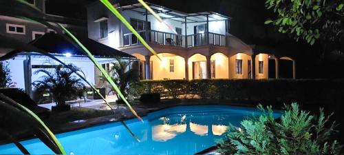 a house at night with a swimming pool in front of it at Serenity Villa in Balaclava