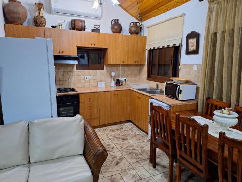 a kitchen with a couch and a table with a microwave at Koukaki in Kouka