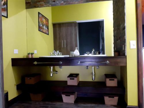 a bathroom with a sink and a mirror at Posada Alma del Cerro in El Calafate