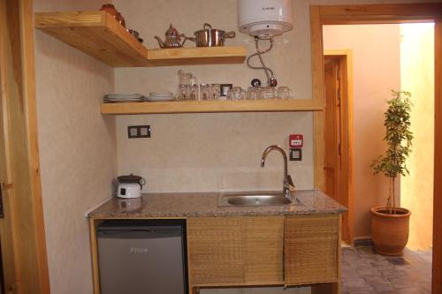 a kitchen with a sink and a counter at SurfAppart Morocco in Tamraght Ouzdar