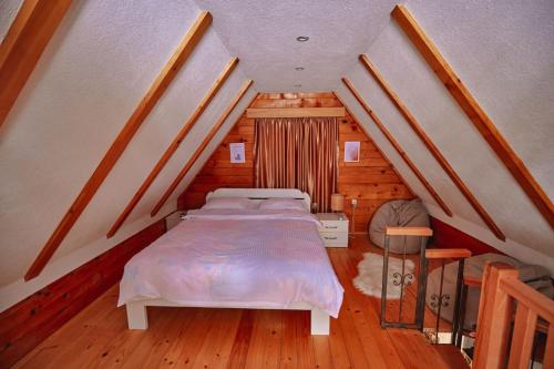 a bedroom with a bed in a attic at Brvnare Tomovic in Mateševo