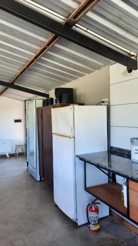 a garage with a refrigerator and a table in it at La Quinta de LOS ABU in Ramallo