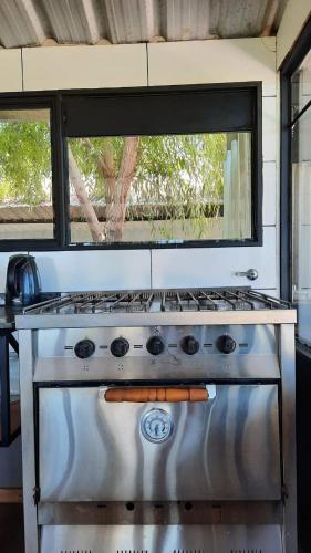 a stove top oven with a window above it at La Quinta de LOS ABU in Ramallo