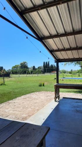 a pavilion with a picnic table in a field at La Quinta de LOS ABU in Ramallo