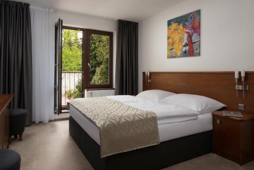a bedroom with a large bed and a window at Penzion Integrity in Brno