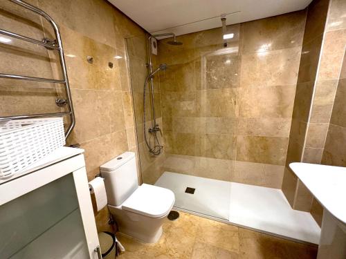 a bathroom with a toilet and a shower at 111 marina duquesa in Manilva