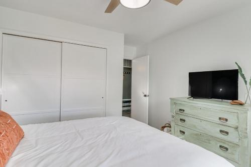 a bedroom with a bed and a tv on a dresser at Harrisonburg Home with Deck - 2 Mi to JMU! in Harrisonburg