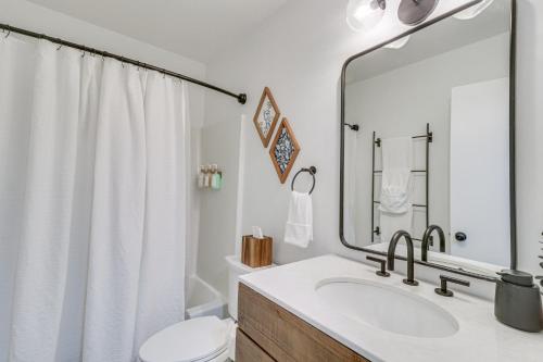 a bathroom with a sink and a toilet and a mirror at Harrisonburg Home with Deck - 2 Mi to JMU! in Harrisonburg