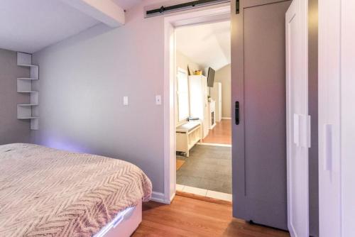 a bedroom with a bed and a door leading to a hallway at The Lilly Pad-Luxury in Sylvan Beach in Blossvale