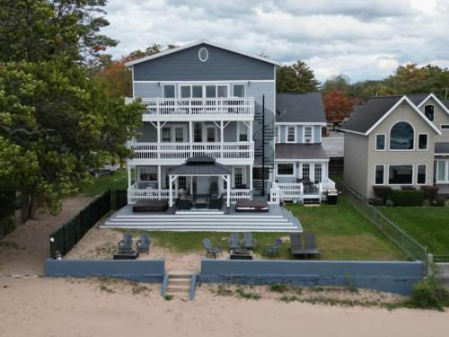 a large white house on the beach at " The Penthouse" Historic Oneida Lakefront Condo 5 in Blossvale