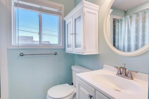 a bathroom with a toilet and a sink and a mirror at Mystic Island Bay Breeze in Little Egg Harbor Township