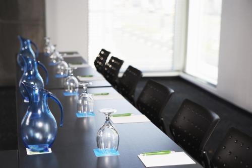 a row of blue glass vases sitting on a table at Hôtel Alt Quartier DIX30 in Brossard