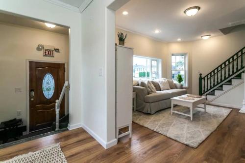 a living room with a couch and a table at Luxurious 5 BR Home in the Heart of Sylvan Beach in Blossvale