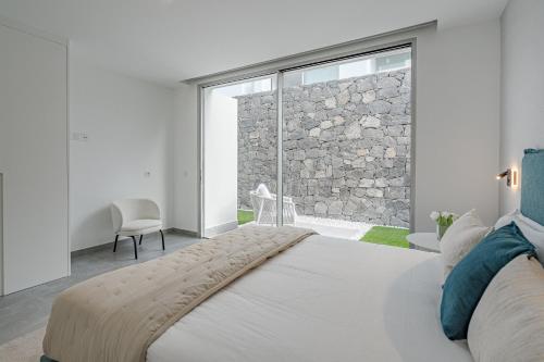 a bedroom with a bed and a large window at Villa Estándar 5 - Casangular by Upper in Adeje